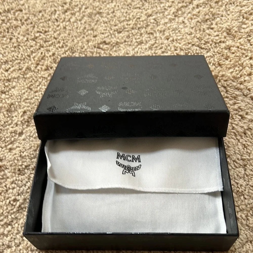 MCM men's lion embossed black with blue and grey mini zipped coin card holder